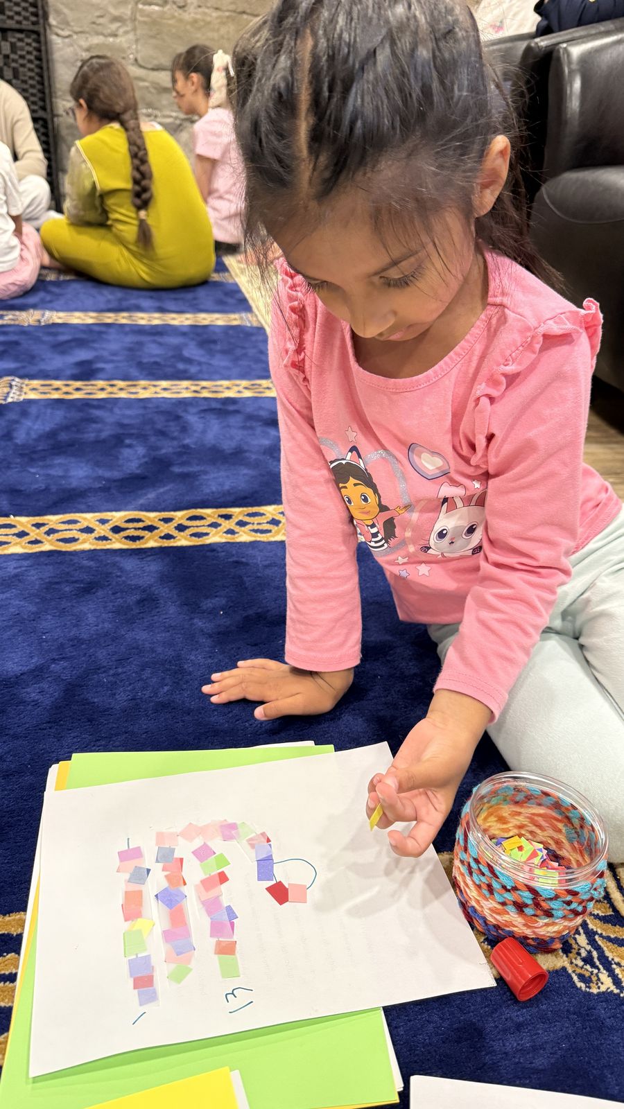 Child participating in a Qur’an learning activity in Cochrane